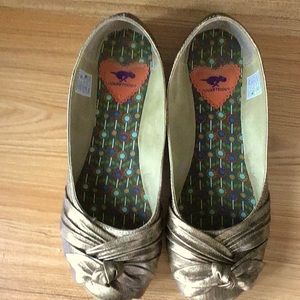 Women’s gold flat shoes.